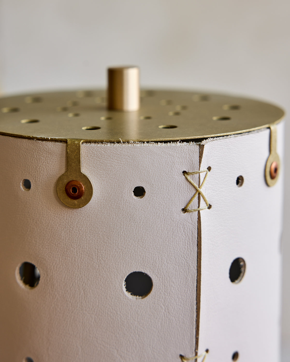 Charming accent lamp with white handstitched leather shade, warm brass and walnut wood