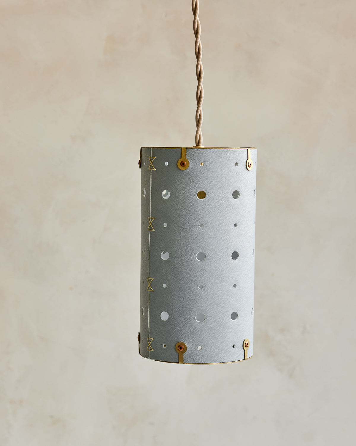 Charming leather pendant light with blue handstitched shade and brass accents