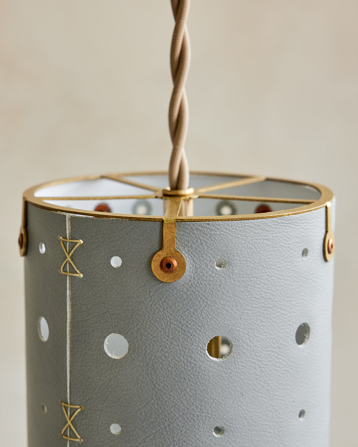 Charming leather pendant light with blue handstitched shade and brass accents