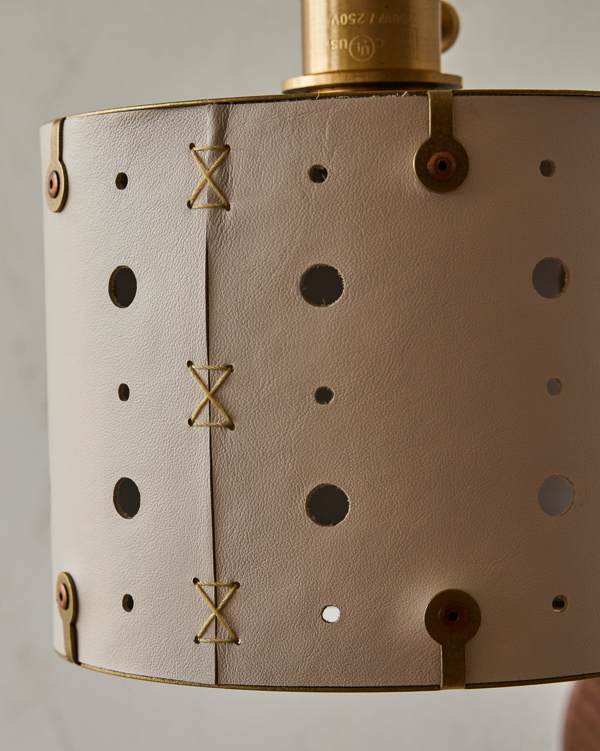 Articulating satin brass plug-in wall sconce with white handstitched shade and walnut backplate