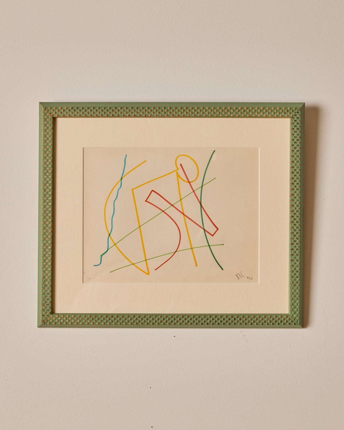 Framed abstract artwork with colorful lines on a beige background