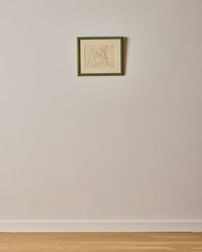 Framed artwork on a plain wall with a wooden floor.
