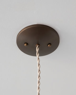 Modern mirrored cone pendants with oil rubbed brass. Hardwired light fixture. Simple interior design, made in the USA.