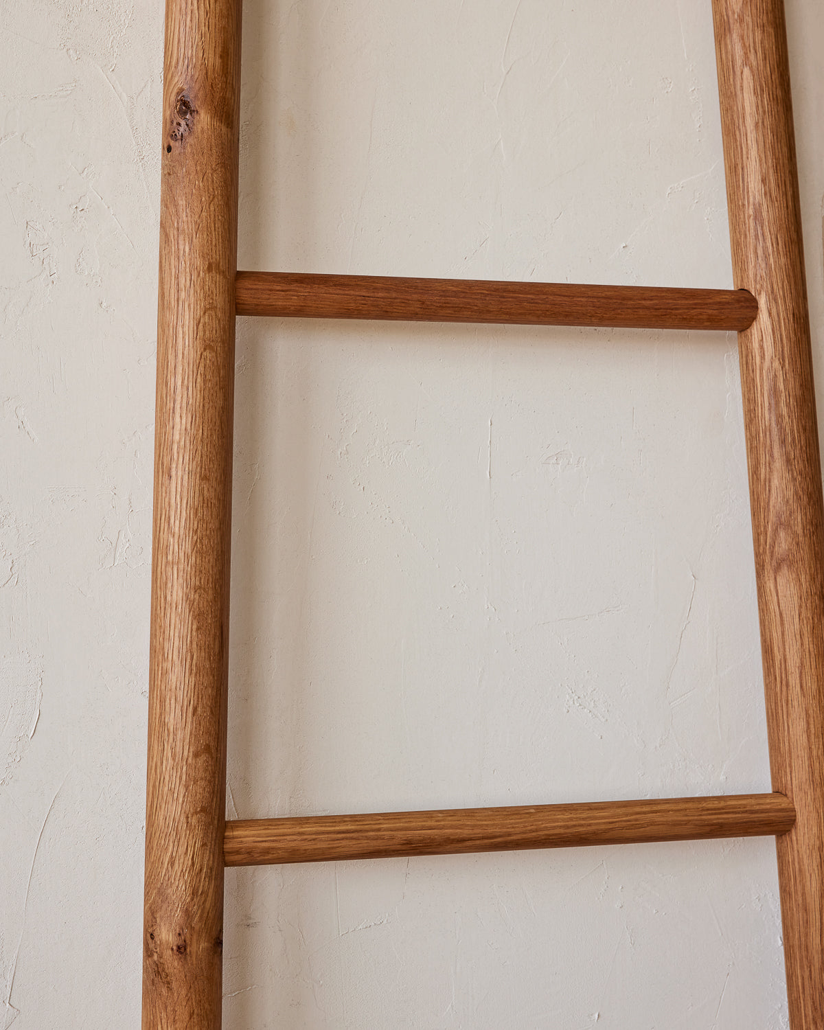 Reclaimed white oak decorative ladder from Lostine. Simple interior design, made in the USA. Warm American Modern Design