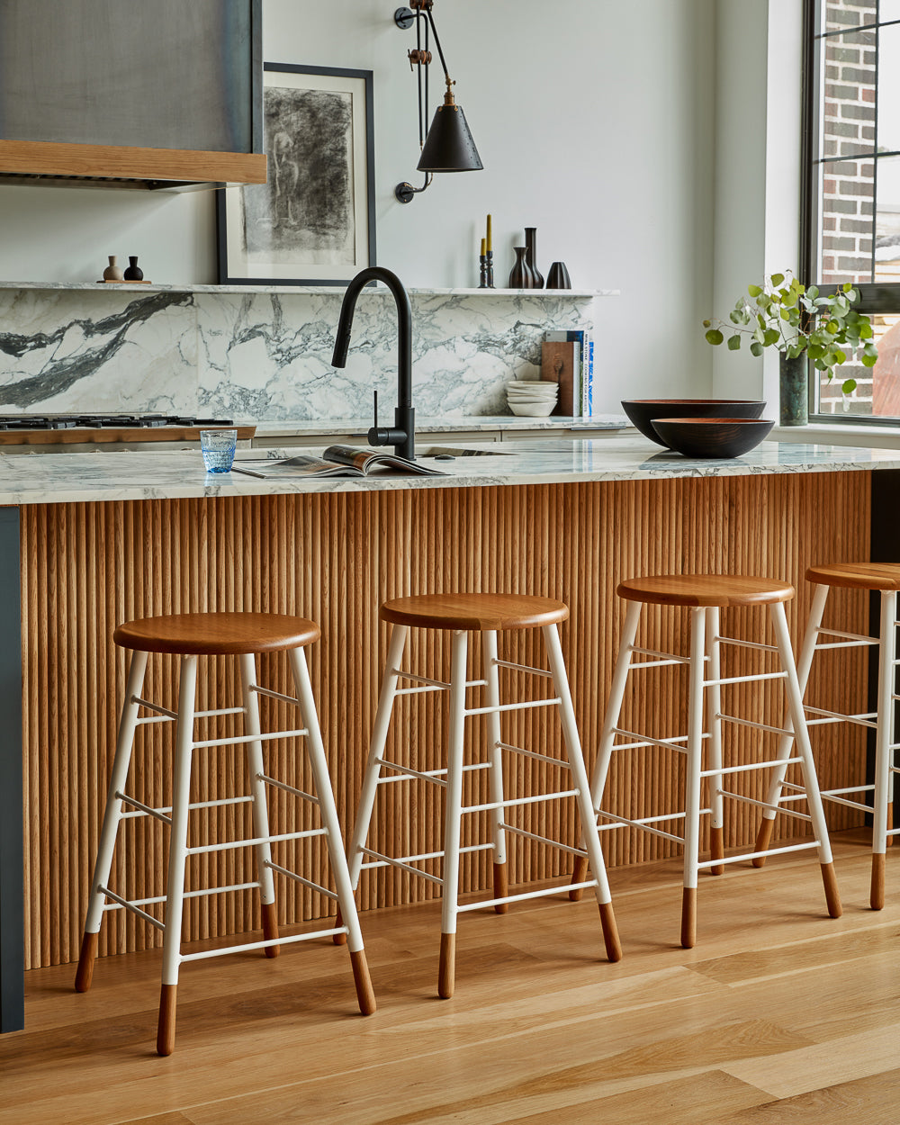 LOSTINE GORDON STOOL - WHITE BASE at modern kitchen counter with marble countertops - Classic ladder metal base stool with wooden seat and feet, workshop stool. Counter and bar height. Made by Lostine in Philadelphia. Simple interior design, made in the USA. Warm American Modern Design