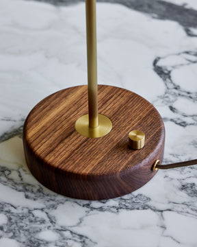 Charming accent lamp with blue leather, warm brass and walnut wood