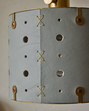 Articulating satin brass sconce with blue handstitched shade and walnut backplate