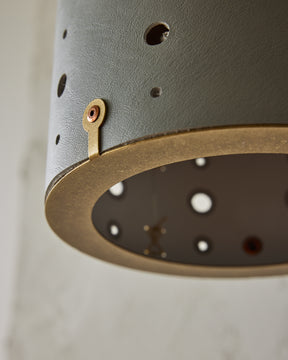 Articulating satin brass sconce with blue handstitched shade and walnut backplate