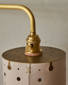 Articulating satin brass plug-in wall sconce with white handstitched shade and walnut backplate