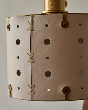 Articulating satin brass plug-in wall sconce with white handstitched shade and walnut backplate