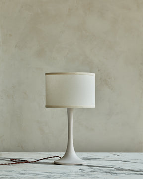 Small Trumpet table lamp with white wash finish and ivory drum shade
